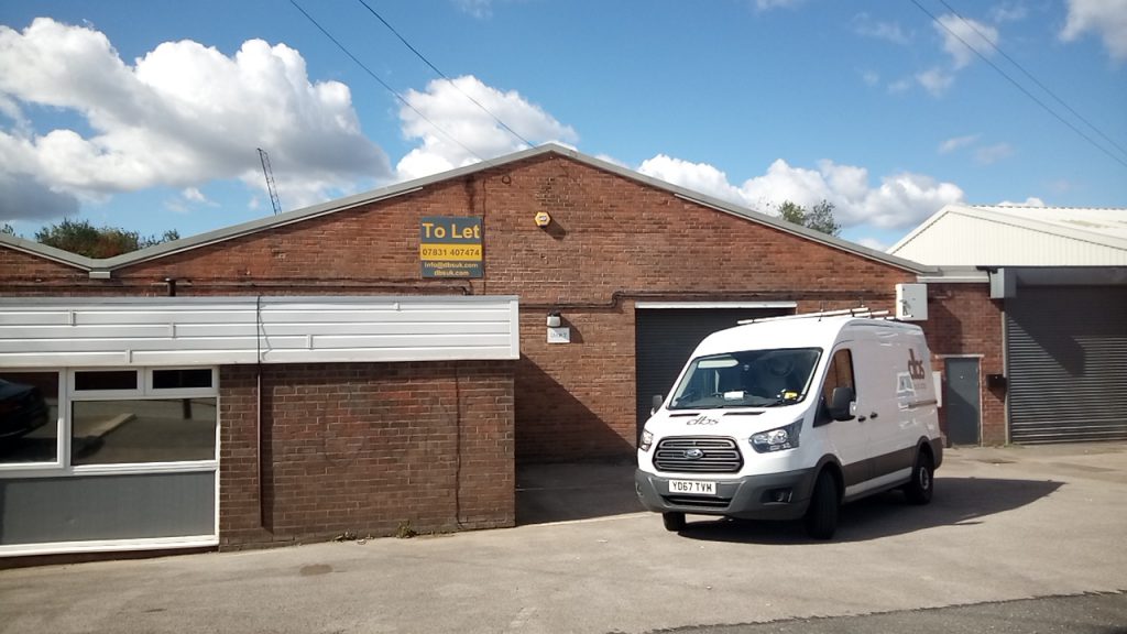 warehouse unit with van parked in front 