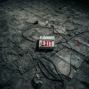 an exit sign sitting in a pile of rubble